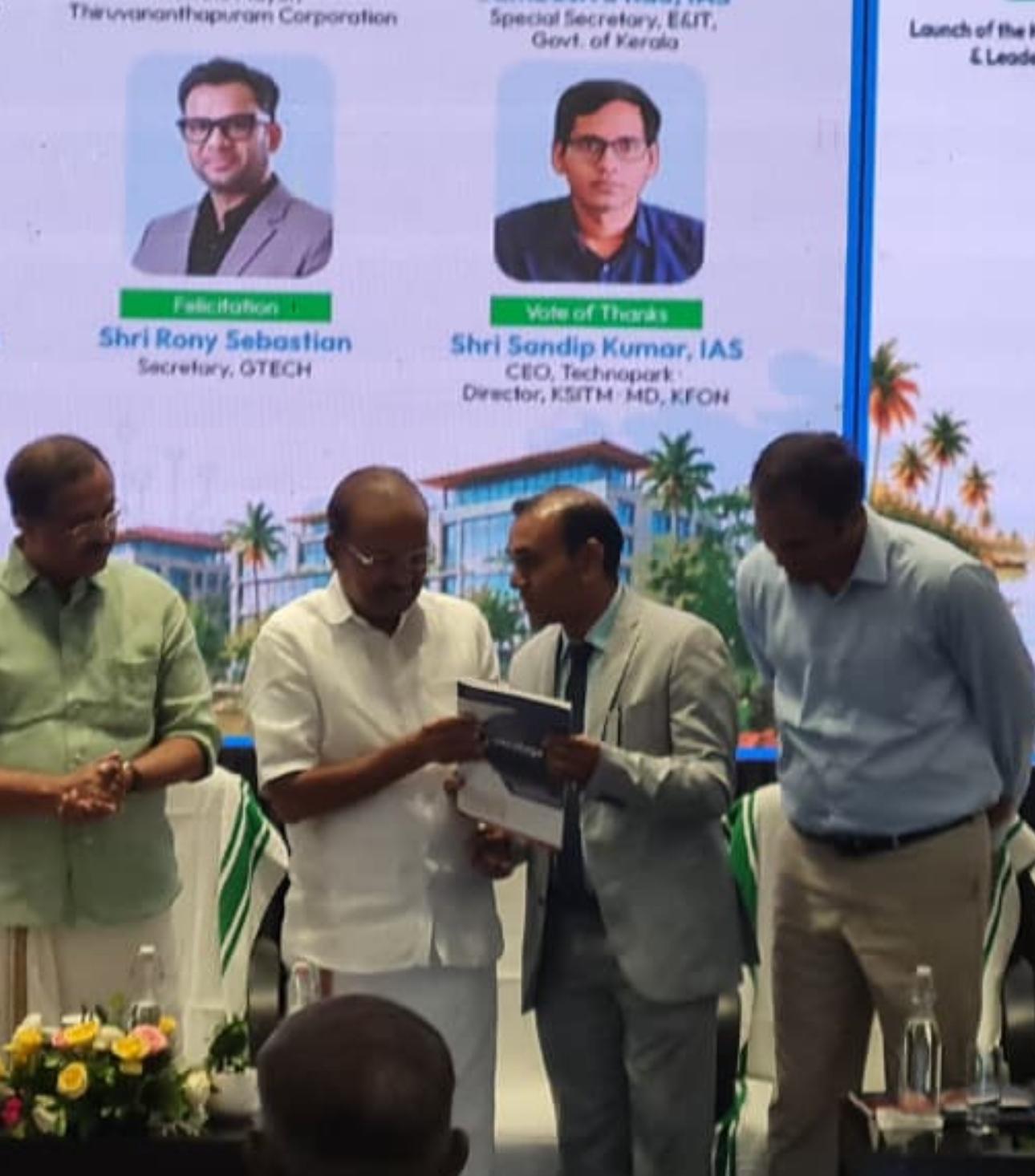The Kerala GCC Feasibility Report being presented on stage.